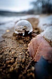 Looking down a beach towards a lens ball.